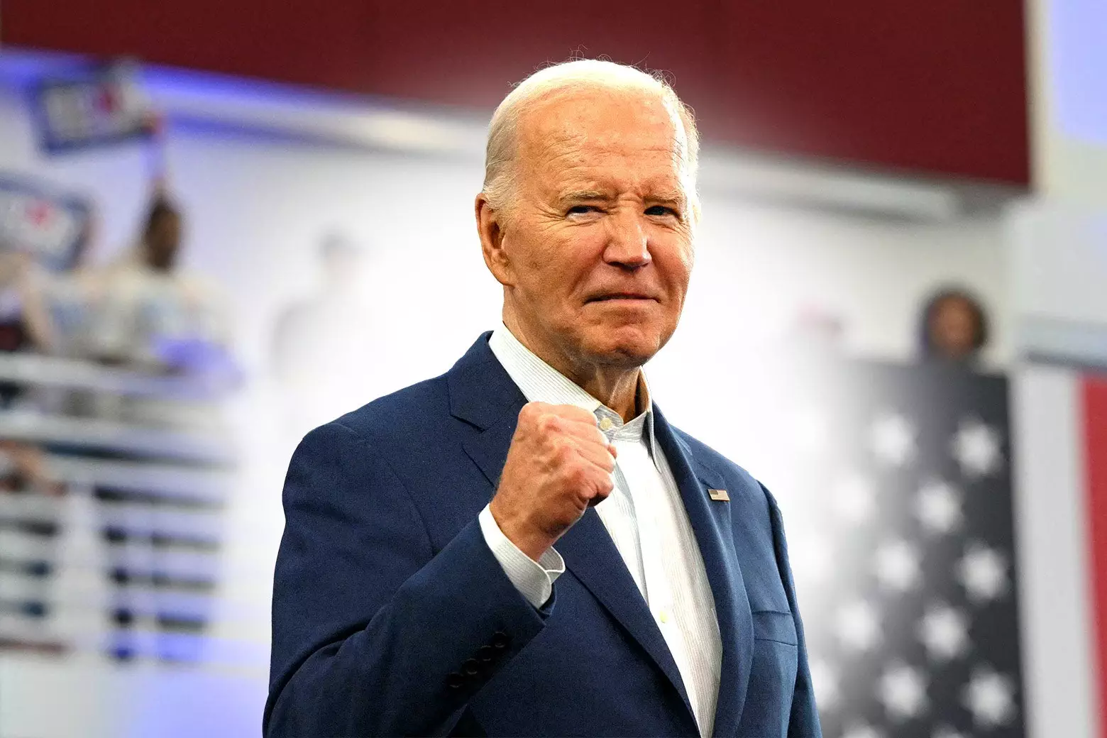 Politics tamfitronics Joe Biden pumping his fist and smiling grimly with a halo around him.