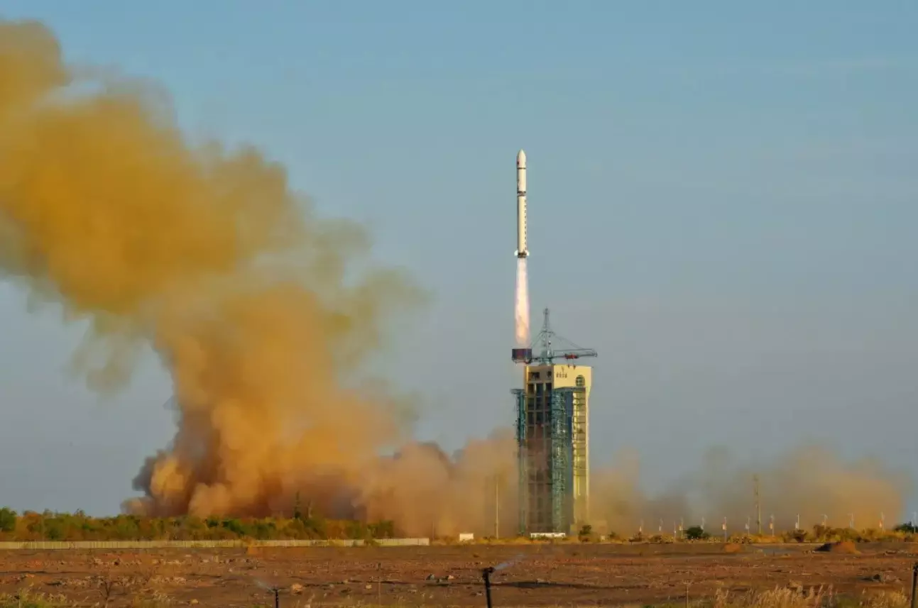 Top Stories Tamfitronics Orange exhaust billows out from the pad as a Long March 2D rocket climbs into a clear blue sky, propelled by purple exhaust exhibiting Mach shock diamonds