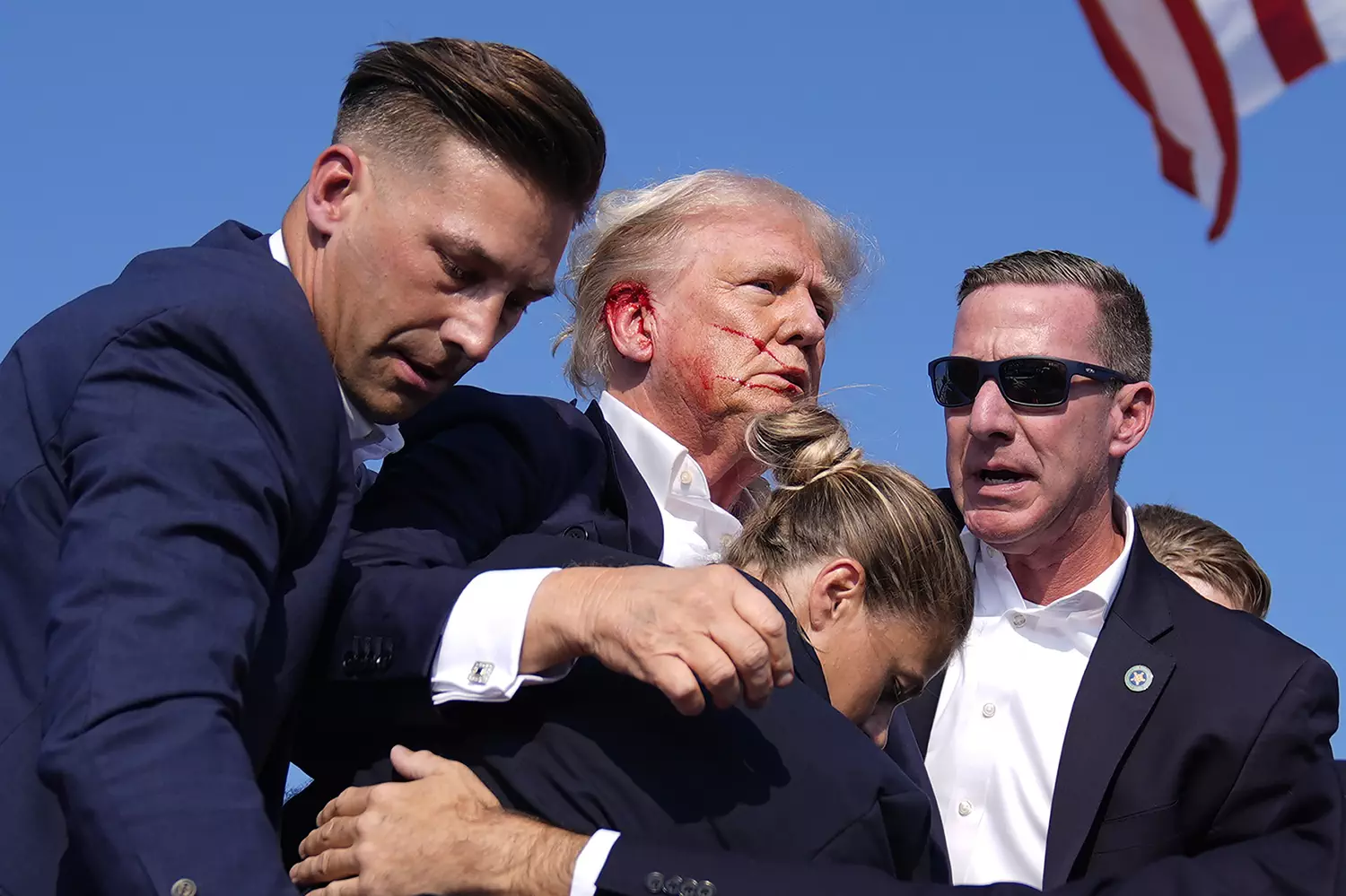 Politics tamfitronics Republican presidential candidate former President Donald Trump gestures as he is surrounded by U.S. Secret Service agents at a campaign rally, Saturday, July 13, 2024, in Butler, Pa. (AP Photo/Evan Vucci)