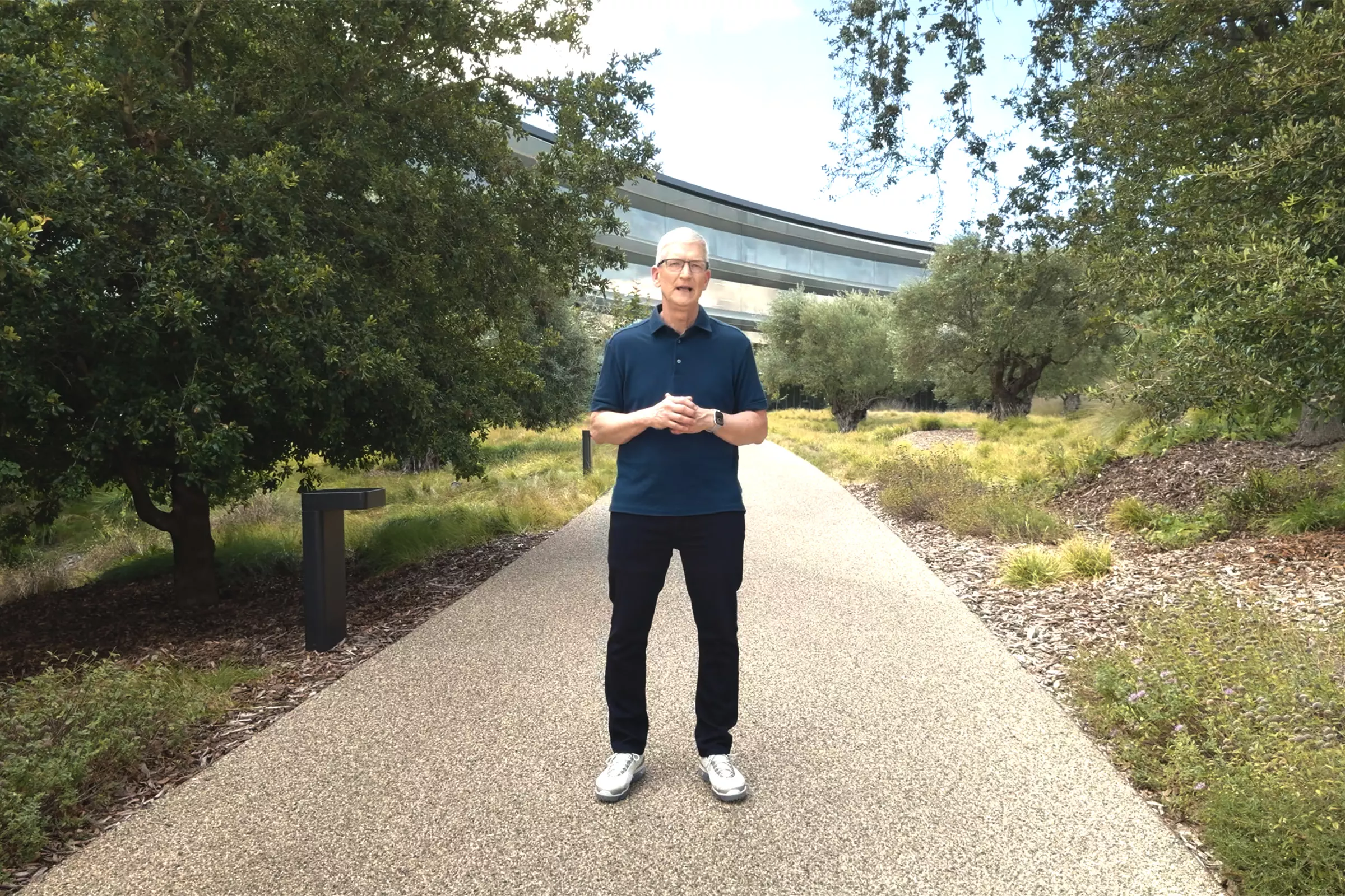 Top Stories Tamfitronics Tim Cook standing in front of Apple Park