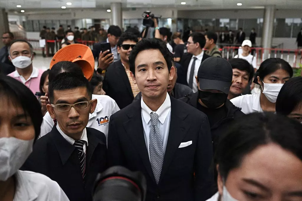 Politics tamfitronics Former Thai prime ministerial candidate and former Move Forward Party (MFP) leader Pita Limjaroenrat (C) leaves the Constitutional Court, after it ruled to ban him from politics for 10 years and dissolve his party over his attempt to reform Thailand's royal defamation laws, in Bangkok on 7 August 2024. (Photo by Lillian Suwanrumpha/ AFP)